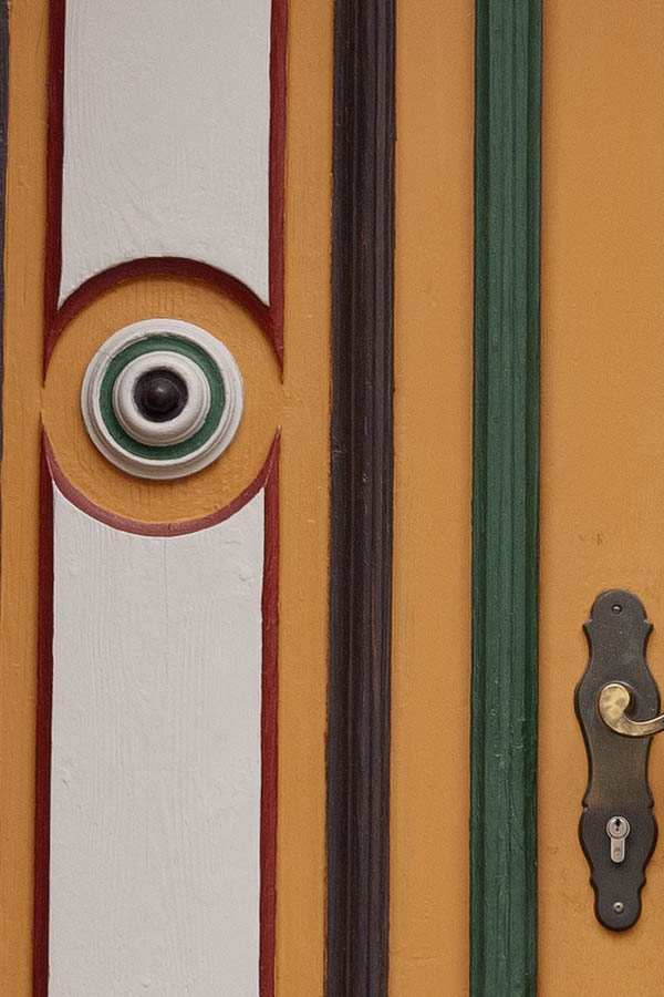 Photo 12652: Carved, panelled, yellow, green, brown, red and white double door with top window