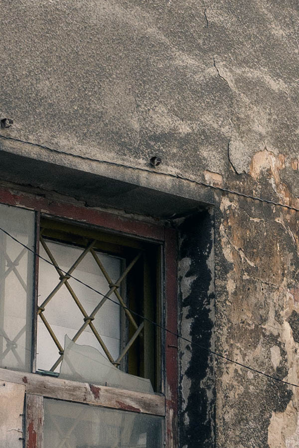 Photo 13151: Worn, grey facade with four windows