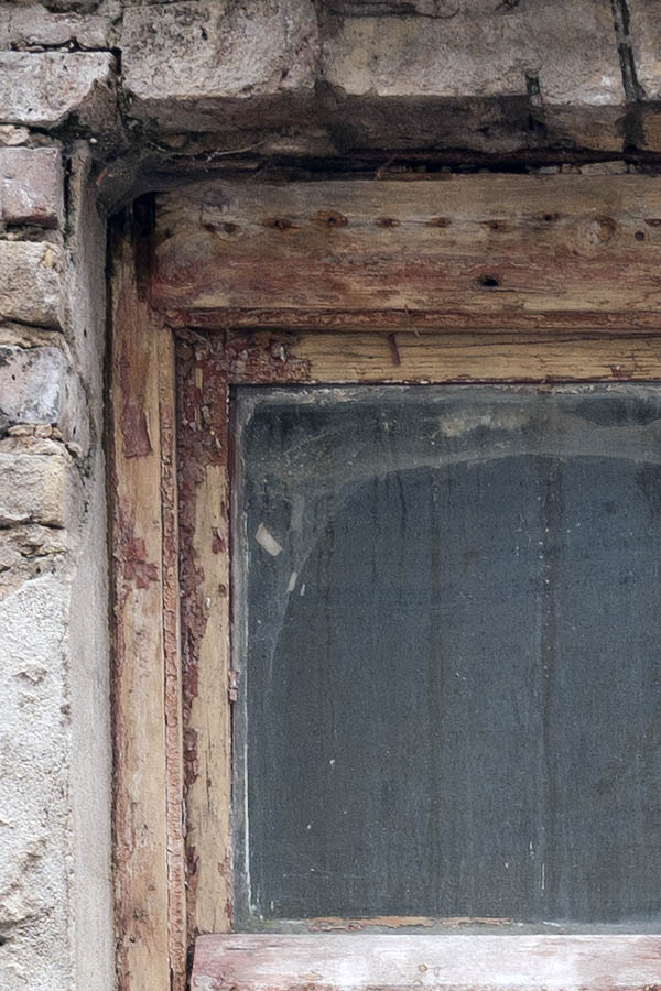 Photo 13330: Worn, lopsided, brown, unpainted window with three frames and five panes