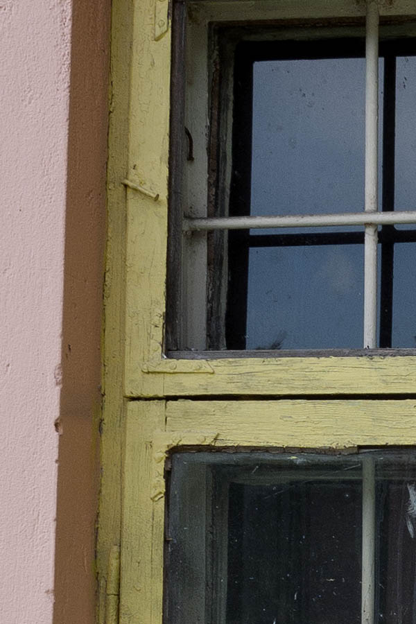 Photo 13336: Yellow, barred window with three frames
