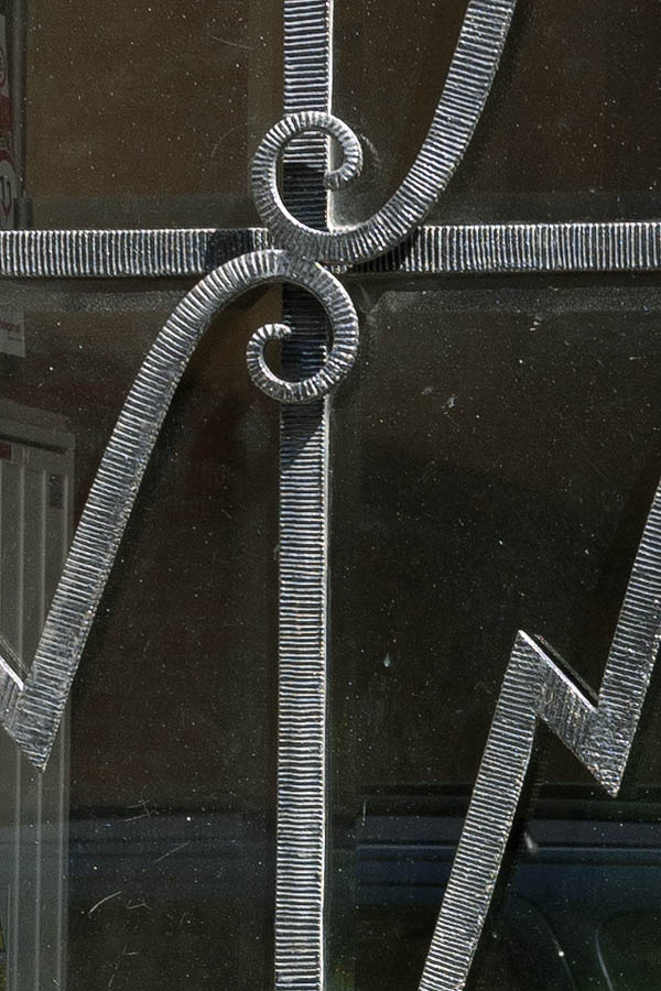 Photo 13442: Grey, hammered metal door with large door light and grating