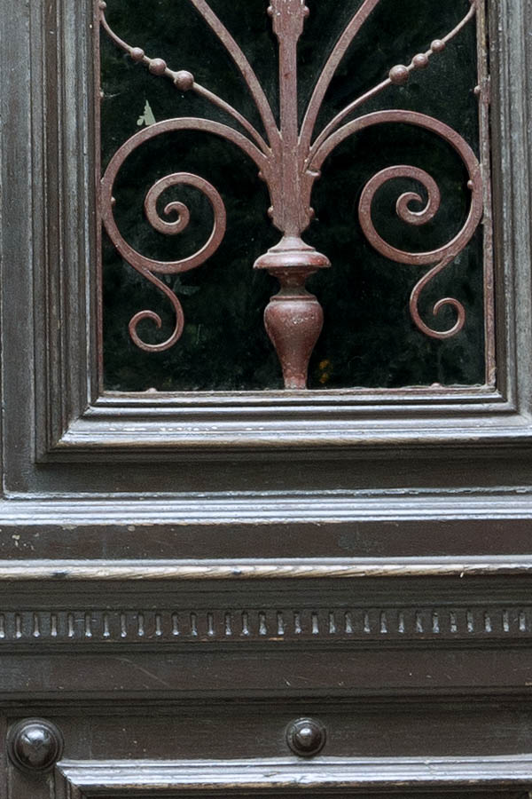 Photo 13554: Worn, carved, panelled, brown double door with latticed door lights