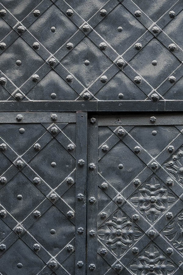 Photo 13606: Black gate with metal decoration and minor door