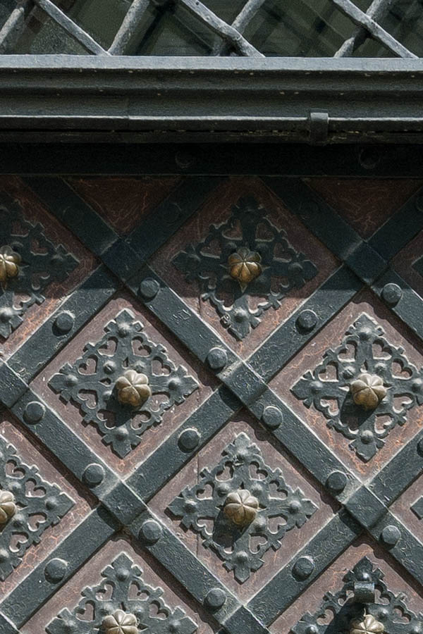 Photo 13817: Brown door with latticed fan light, decorated with black metal