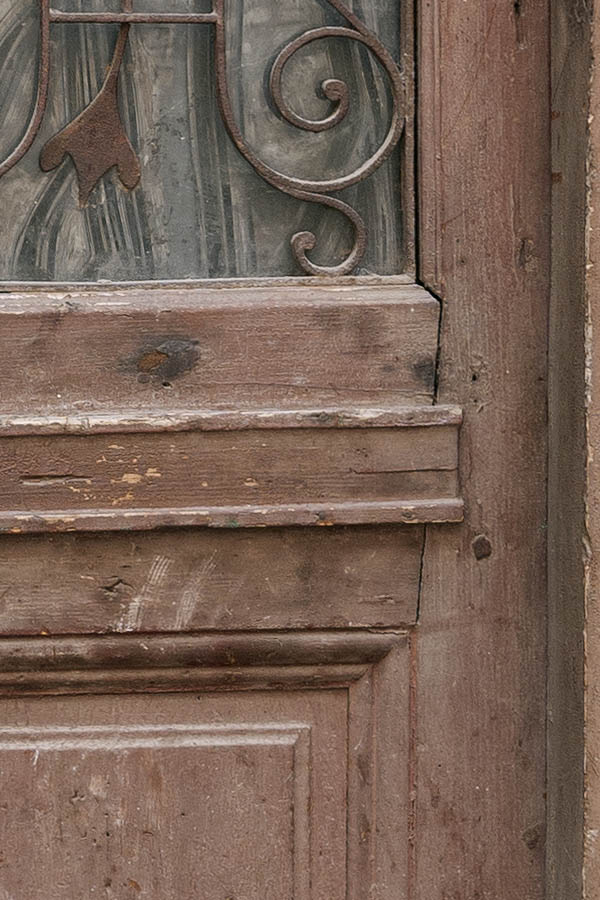 Photo 13893: Decayed, panelled, light brown door with latticed door light