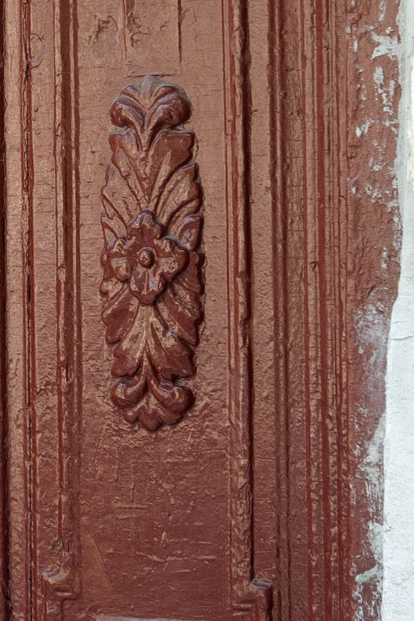 Photo 13935: Worn, carved, panelled, brown double door with latticed door lights