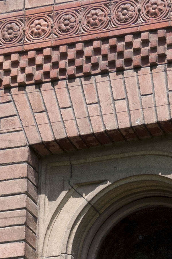 Photo 13962: Formed, brown double window with sandstone post