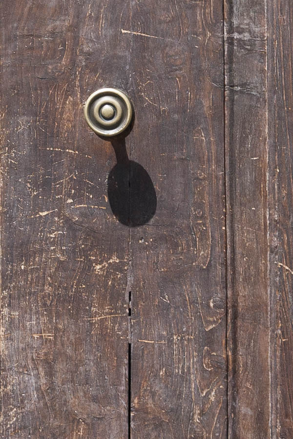 Photo 14720: Worn, panelled, brown double door with barred fan light