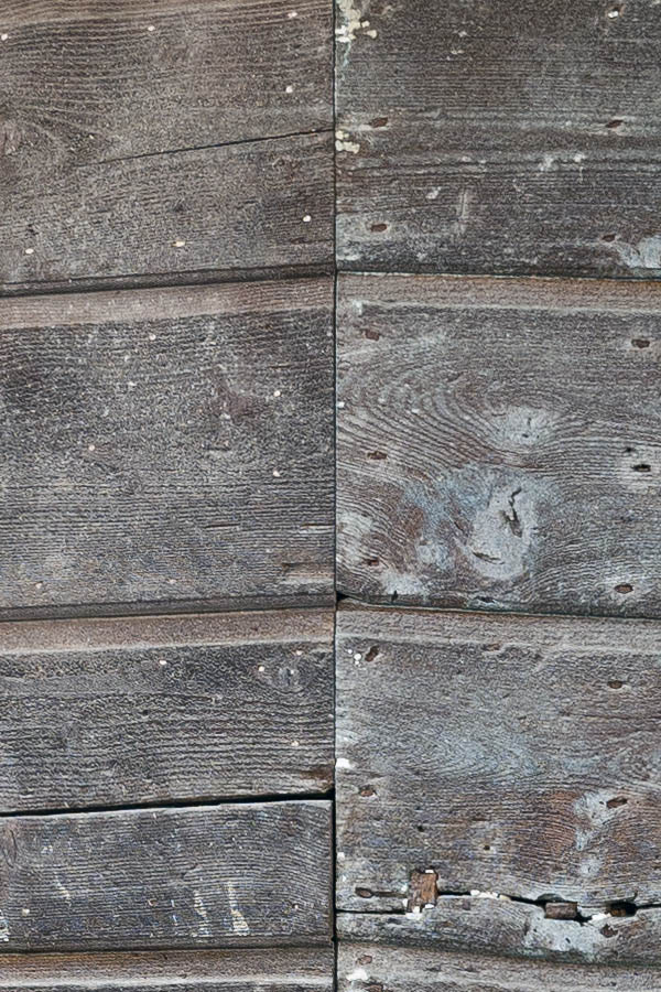 Photo 14769: No door. A wide, door covered with spiked, brown, unpainted planks.