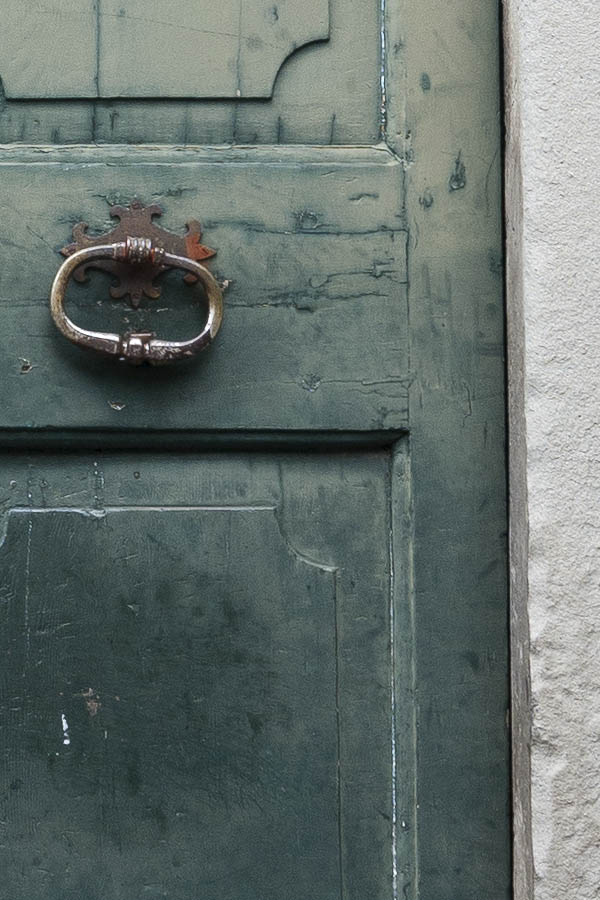 Photo 14977: Worn, panelled, green double door with barred, white fan light
