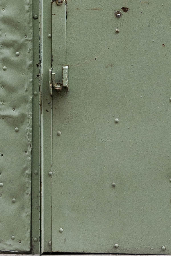 Photo 15519: Worn, light green folding gate made of planks with minor door