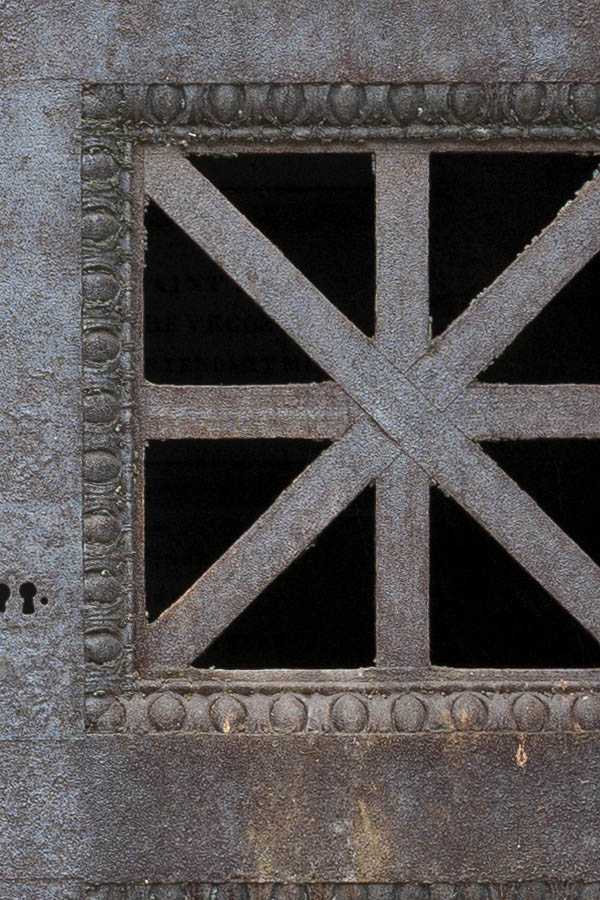 Photo 15600: Worn, rusty, brown metal double door with barred door lights