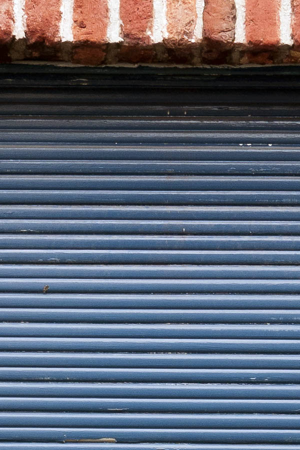 Photo 15690: Worn, blue security shutter. .
