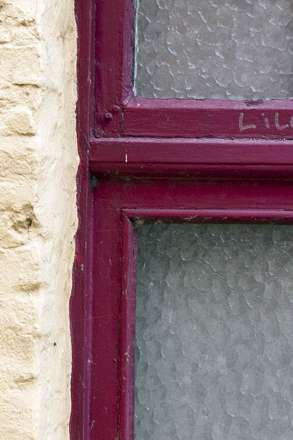 Photo 15786: Worn, purple window with two frames and nine panes with matted glass