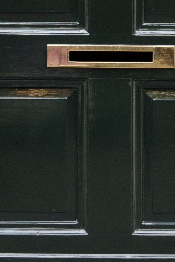 Photo 16156: Panelled, lopsided, black door in a white frame