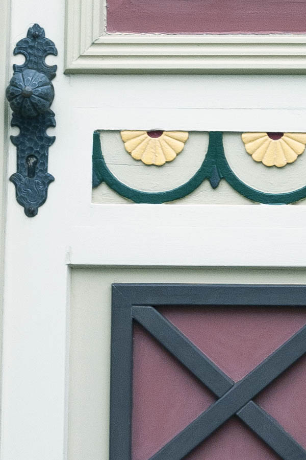 Photo 16204: Panelled, carved, red, green, yellow and white door with top window