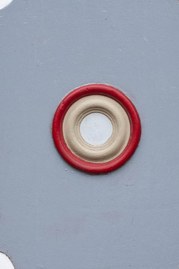 Photo 16215: Worn, panelled, grey, white, red and orange door with white top window