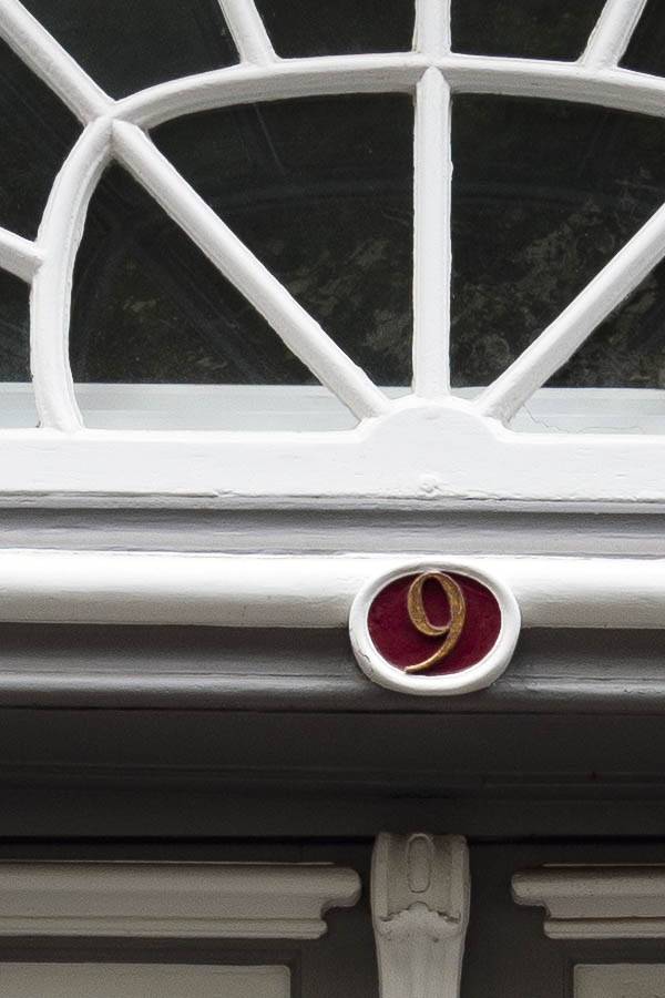 Photo 16271: Panelled, carved, formed, grey, white and red double door with top window