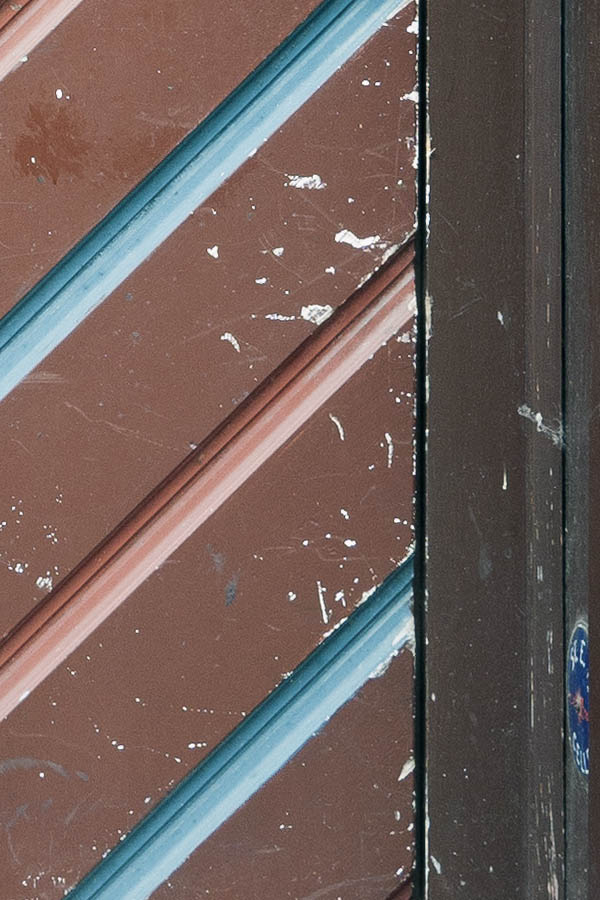 Photo 16296: Brown, blue and red door made of planks with white top window