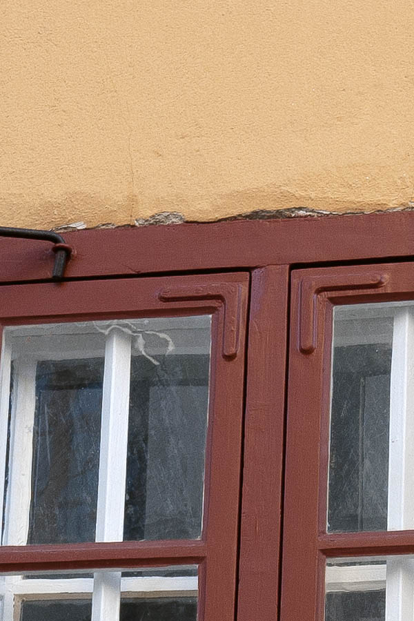 Photo 17616: Barred, red window with two frames, 12 panes and black shutters