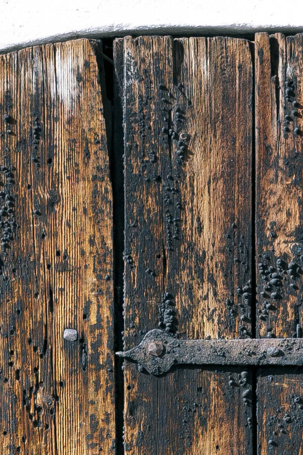 Photo 17969: Decayed, formed, black and unpainted door of boards