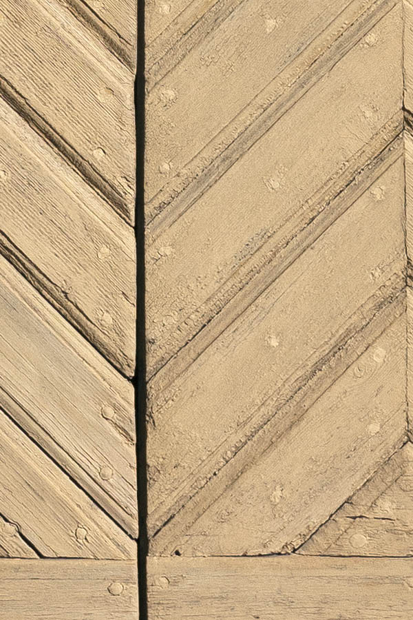 Photo 18023: Light yellow double door of diagonally mounted boards in a wide, white frame