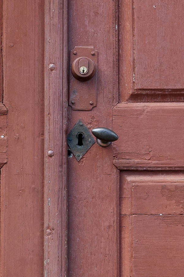 Photo 18065: Worn, panelled, red double door in a white frame