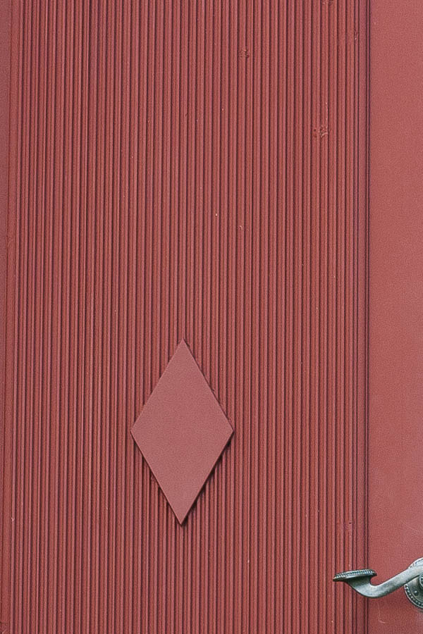 Photo 18105: Panelled, carved, red double door with top window in a white frame