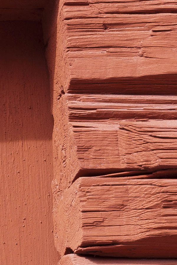 Photo 18188: No window. A hole in a red loghouse barred by boards