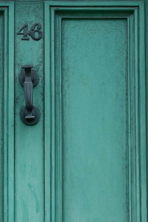 Photo 18760: Worn, panelled, green door with top window in a white frame