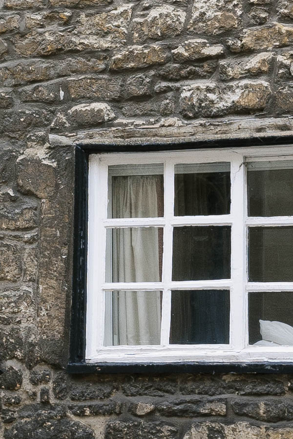 Photo 18825: Facade with a  black door and 12 windows in a black and yellow stone wall
