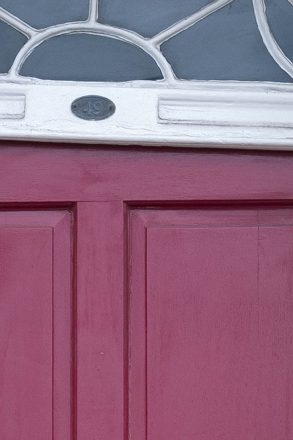 Photo 18918: Lopsided, panelled, cerise red door with a white top window