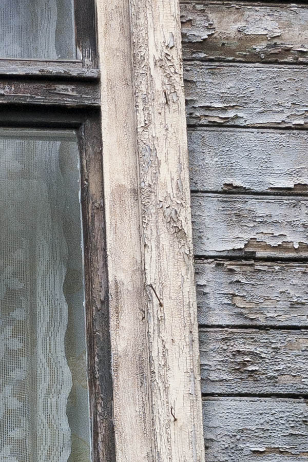 Photo 19002: Worn, brown T-post window with four panes in an unpainted, outer frame