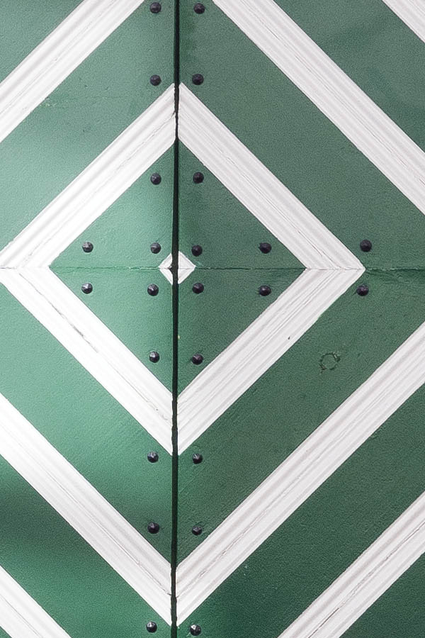 Photo 19885: Formed, white and green double door of diagonally mounted boards
