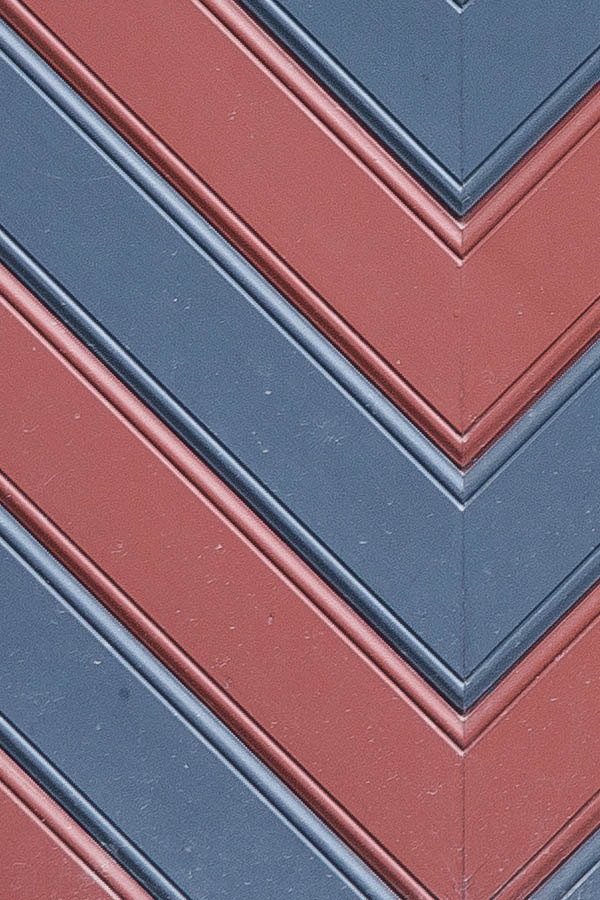 Photo 23875: Formed, red and blue garage door with barred, diamond-shaped door lights