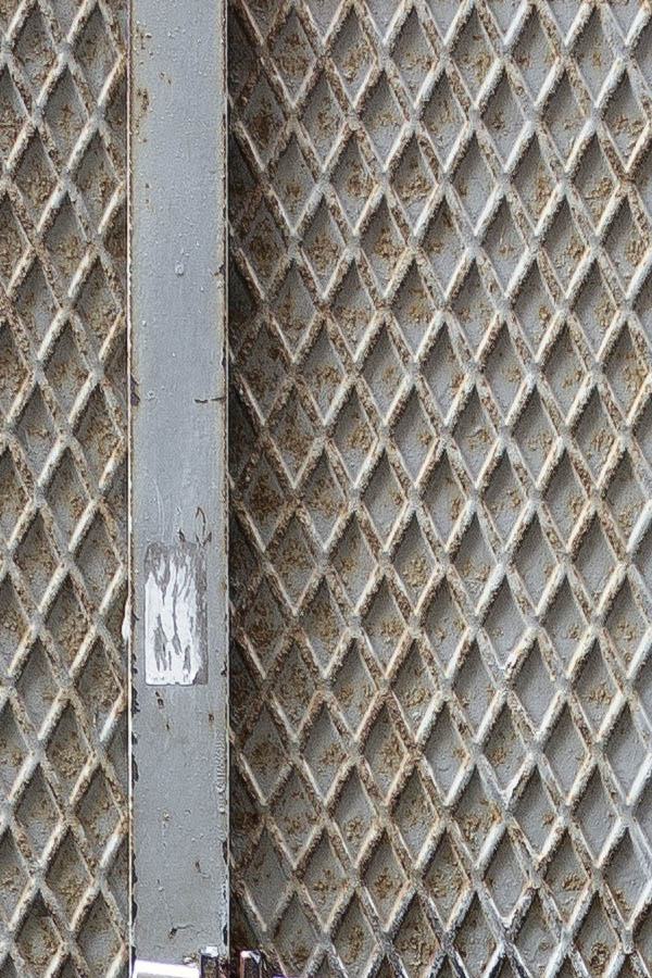 Photo 23905: Worn, grey metal plate door with sidepiece