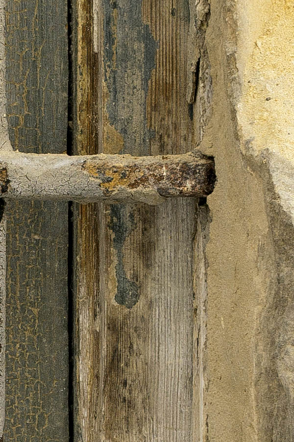 Photo 24088: Decayed, barred, rusty, brown window with one pane