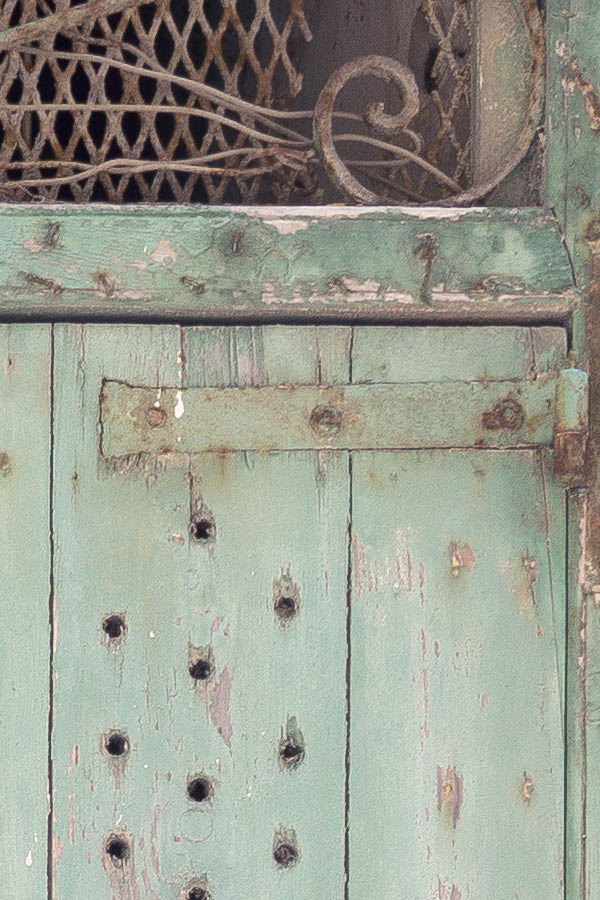 Photo 24091: Decayed, light green door of planks with latticed top window