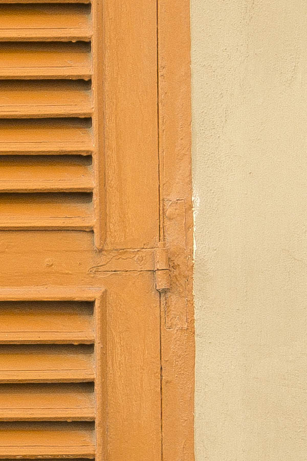 Photo 24255: Yellow-washed facade with an orange, shuttered window