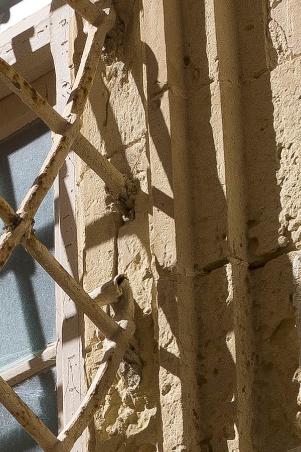 Photo 24271: Large, barred, yellow window with plastered pilaster