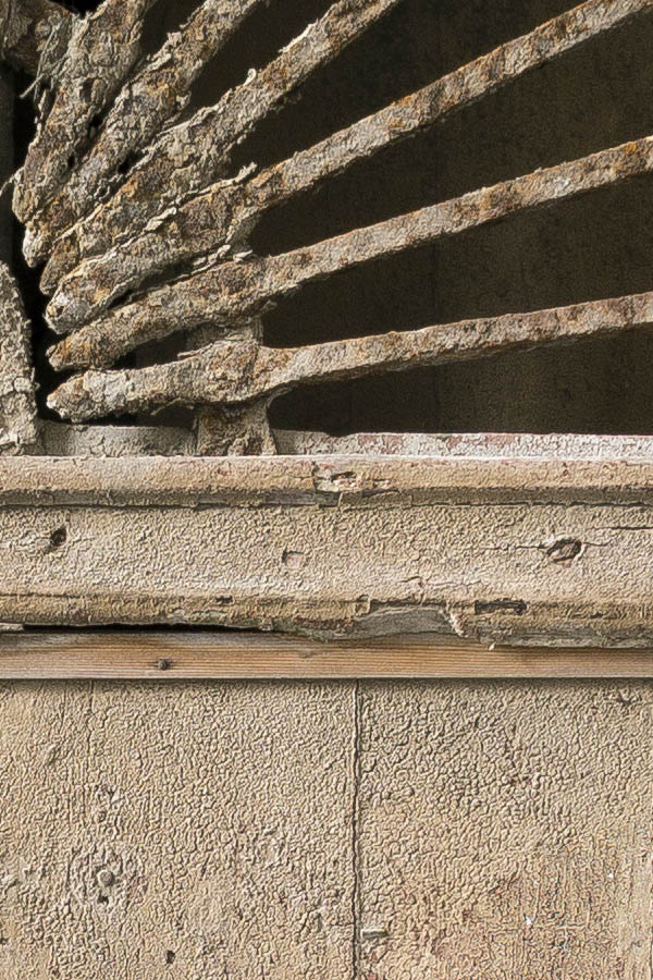Photo 24409: Lopsided, worn, unpainted, brown double door of boards with latticed fan light