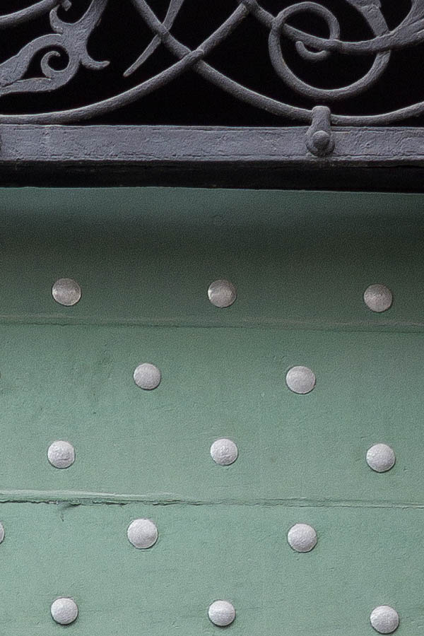 Photo 24975: Green gate of horizontal boards with many nails, minor door and latticed fan light