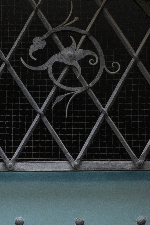 Photo 25000: Teal gate of boards with nails and latticed, barred fan light