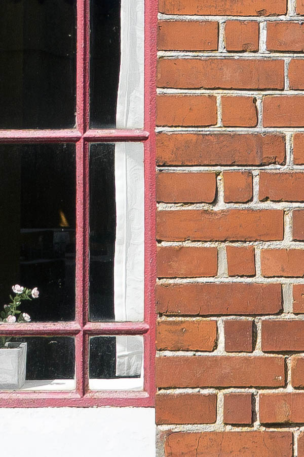 Photo 25231: Facade with four narrow, red metal windows with 20 panes each