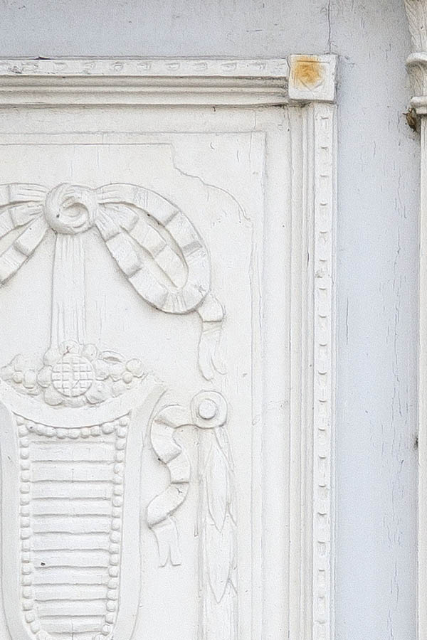 Photo 25243: Worn, panelled, grey and white double door with carved panels and top window with coloured glass