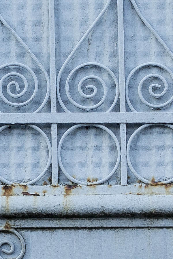 Photo 25642: Grey or blue metal gate with door and decorations