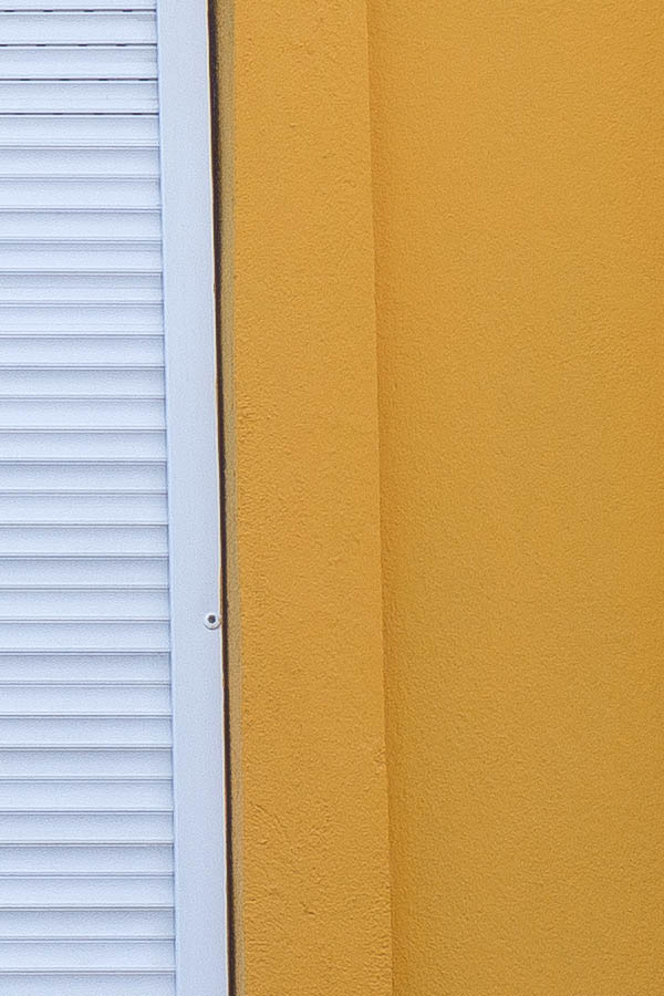 Photo 25647: Chrome yellow facade with white security shutters