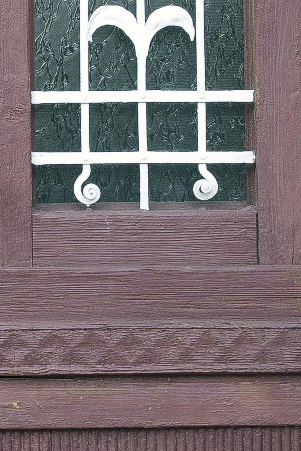 Photo 25656: Narrow, panelled, carved, brown double door with latticed fan light and top window