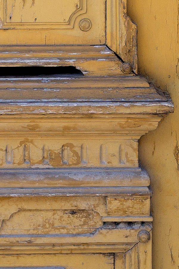 Photo 25719: Worn, panelled, carved, yellow door