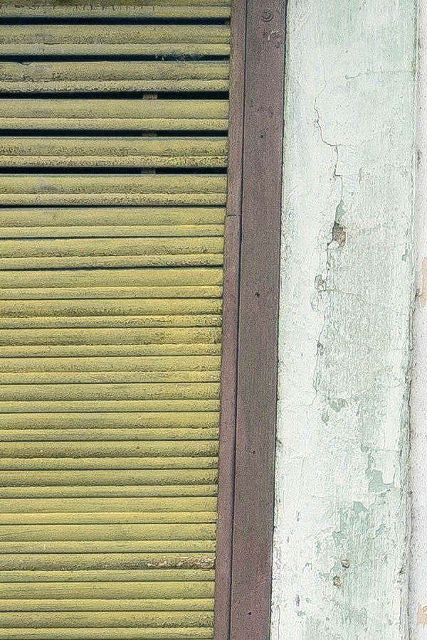 Photo 25761: Facade with two windows covered by yellow and brown security shutters